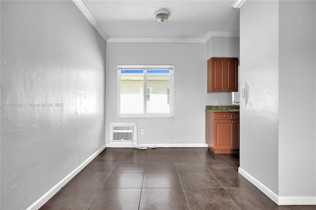 521 NE 82nd Ter, Miami, FL 33138 - unfurnished dining area with dark tile patterned floors, heating unit, crown molding, and baseboards