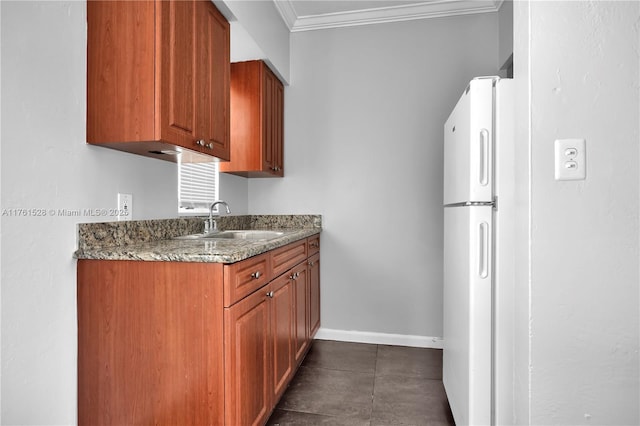 521 NE 82nd Ter, Miami, FL 33138 - kitchen featuring crown molding, baseboards, stone counters, brown cabinets, and a sink