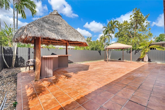 view of patio featuring a gazebo and a fenced backyard