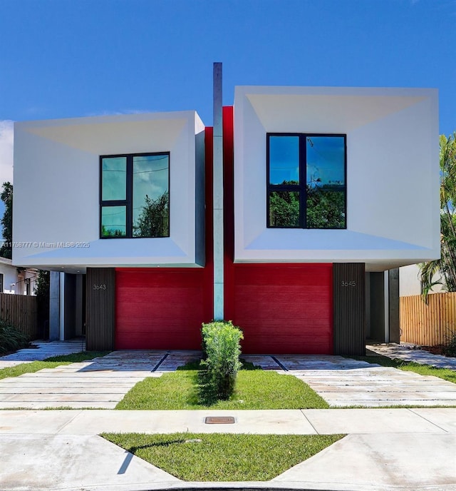 contemporary home with stucco siding and driveway