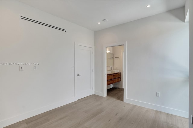unfurnished bedroom with baseboards, light wood-style flooring, and recessed lighting