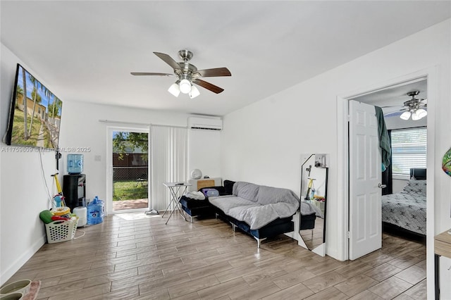 living room featuring a ceiling fan, light wood finished floors, and a wall mounted AC