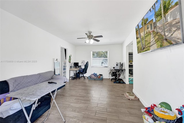 office area with a ceiling fan and wood tiled floor