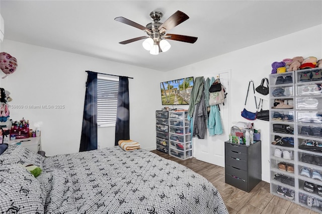 bedroom with wood finished floors and ceiling fan