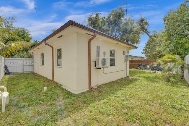 view of property exterior with a fenced backyard, stucco siding, and a yard