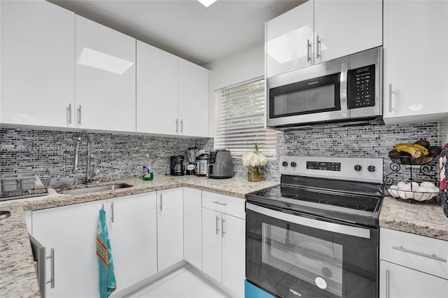 kitchen featuring tasteful backsplash, appliances with stainless steel finishes, and a sink