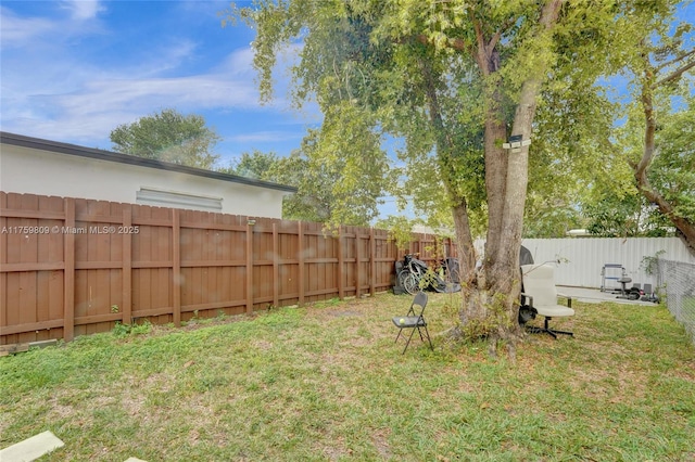 view of yard with a fenced backyard