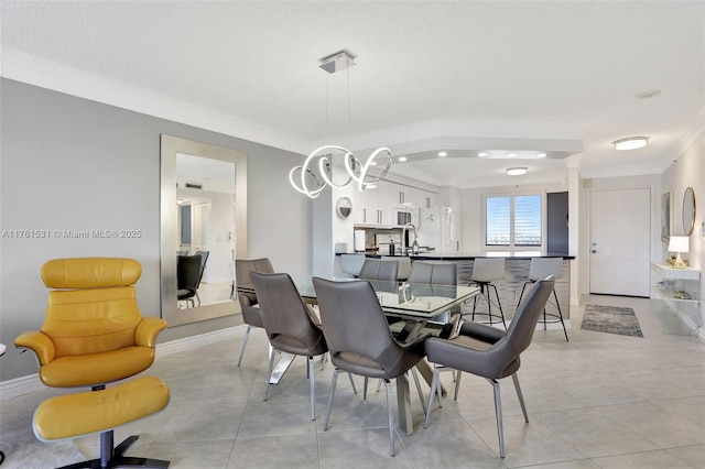 dining space with light tile patterned floors, baseboards, an inviting chandelier, and crown molding