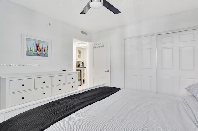 bedroom with a closet, visible vents, and ceiling fan