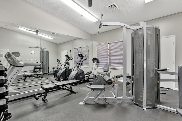 workout area with visible vents and a textured ceiling