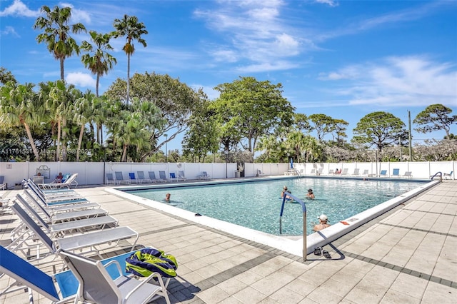 pool featuring a patio area and fence