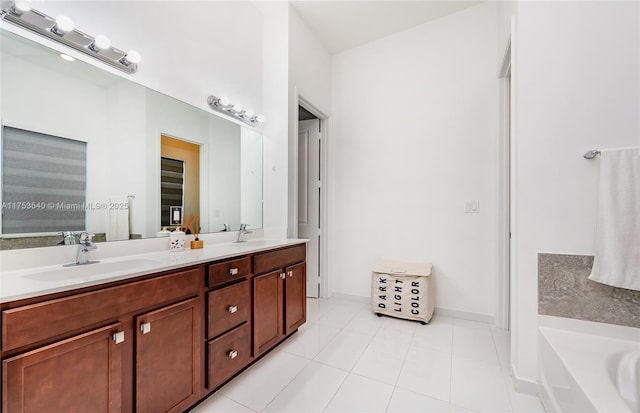 bathroom featuring double vanity, a bathing tub, tile patterned floors, and a sink