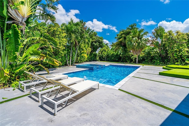 view of swimming pool with a patio and a pool with connected hot tub