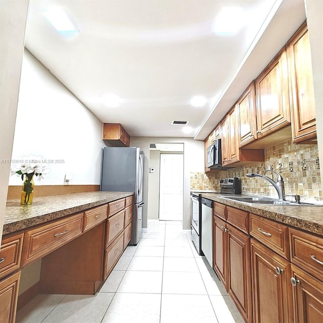 kitchen with visible vents, light tile patterned flooring, appliances with stainless steel finishes, dark countertops, and backsplash