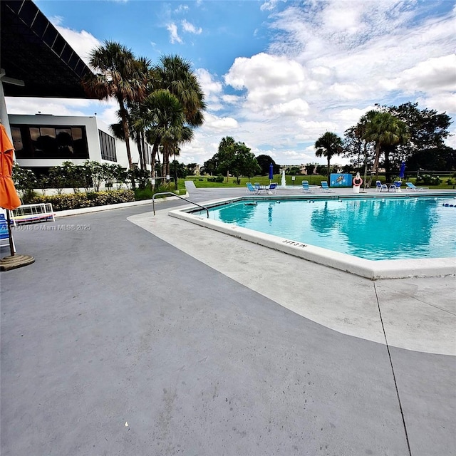 community pool with a patio area