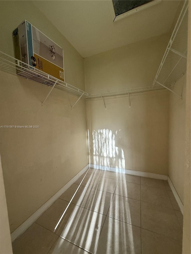 spacious closet with tile patterned flooring