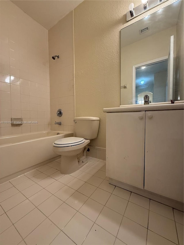 bathroom featuring tile patterned floors, visible vents, toilet, and washtub / shower combination