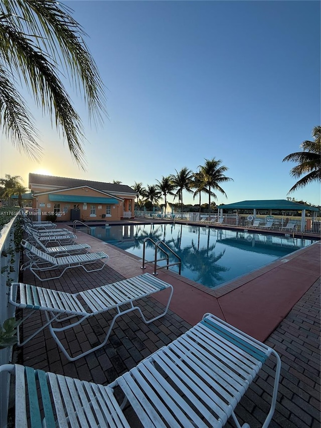 pool at dusk with a community pool