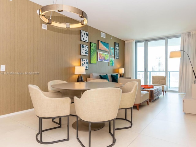 dining space with visible vents, baseboards, and floor to ceiling windows