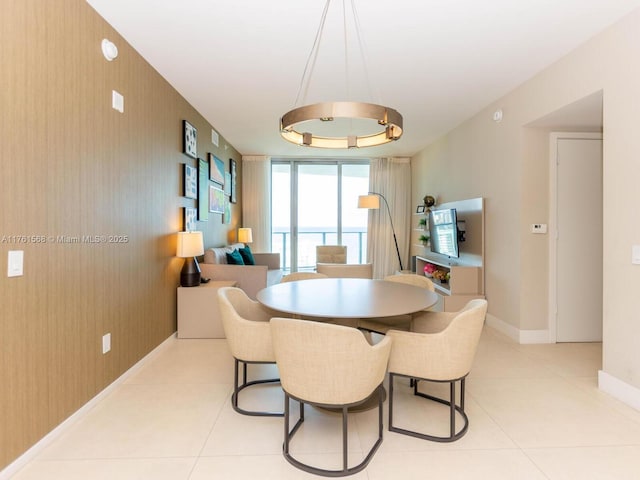 dining room featuring light tile patterned floors and baseboards