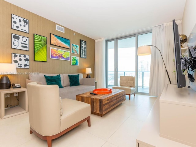 living room with light tile patterned floors, visible vents, and expansive windows