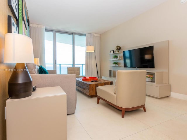 tiled living area with expansive windows and baseboards