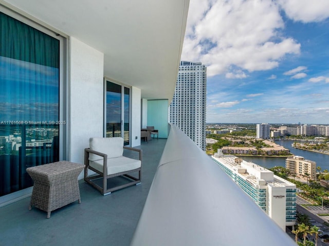 balcony with a water view and a city view