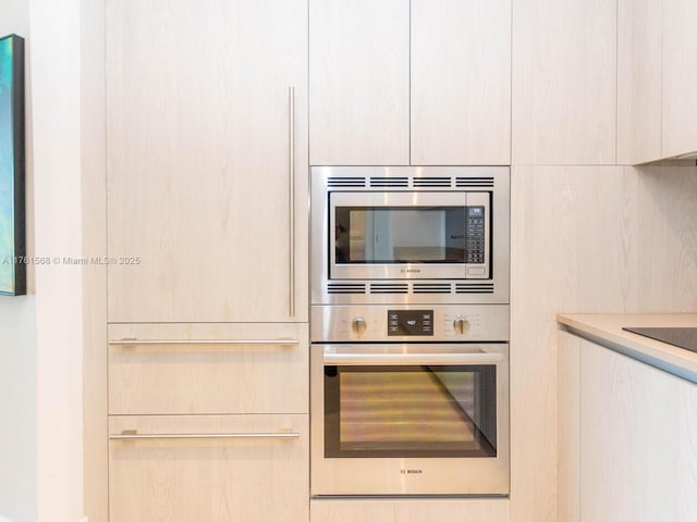 kitchen with light countertops, modern cabinets, and stainless steel appliances