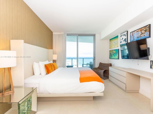 bedroom with tile patterned flooring, access to outside, and expansive windows