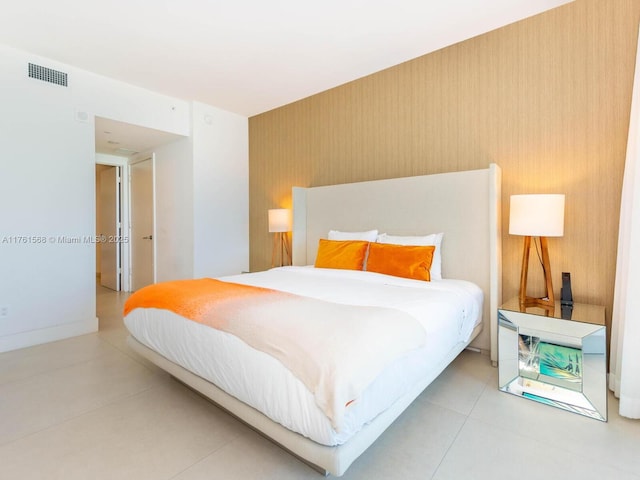 bedroom with tile patterned floors, baseboards, and visible vents