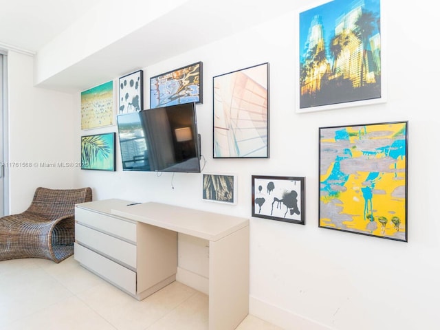 office space with light tile patterned floors and baseboards