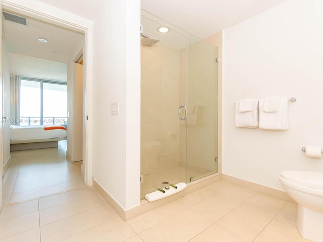 full bathroom with baseboards, tile patterned flooring, a shower stall, ensuite bathroom, and toilet