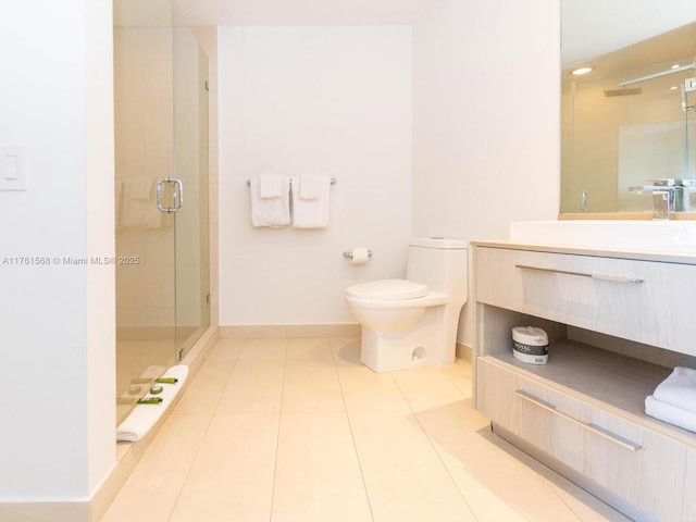 full bath featuring vanity, baseboards, a stall shower, tile patterned floors, and toilet