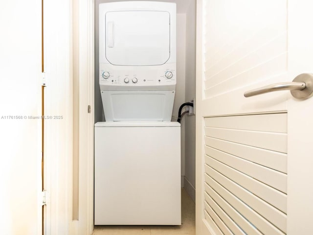 clothes washing area with laundry area and stacked washer / drying machine