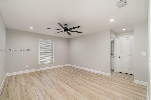 empty room featuring visible vents, ceiling fan, baseboards, and light wood-style floors