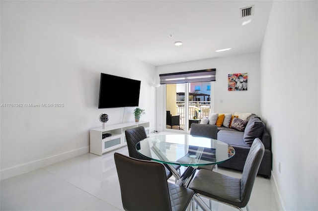 dining area featuring light tile patterned floors, visible vents, and baseboards