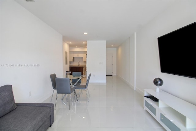 living area with recessed lighting, baseboards, and light tile patterned flooring