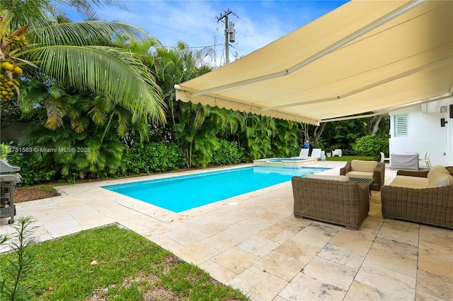 view of pool featuring a patio and a pool with connected hot tub