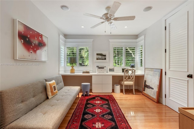 interior space featuring light wood-style flooring, recessed lighting, a ceiling fan, and built in study area