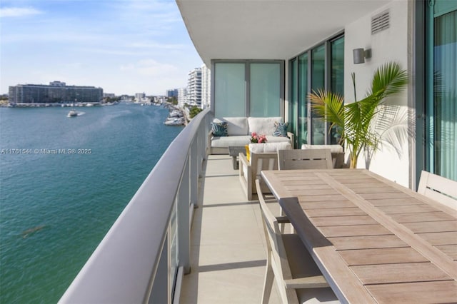 balcony with visible vents and a water view