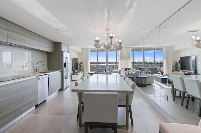 dining area with a wall of windows, light tile patterned flooring, visible vents, and a chandelier