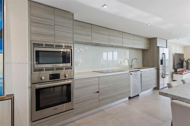 kitchen featuring light countertops, modern cabinets, and stainless steel appliances