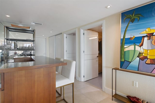 kitchen with a kitchen bar and visible vents