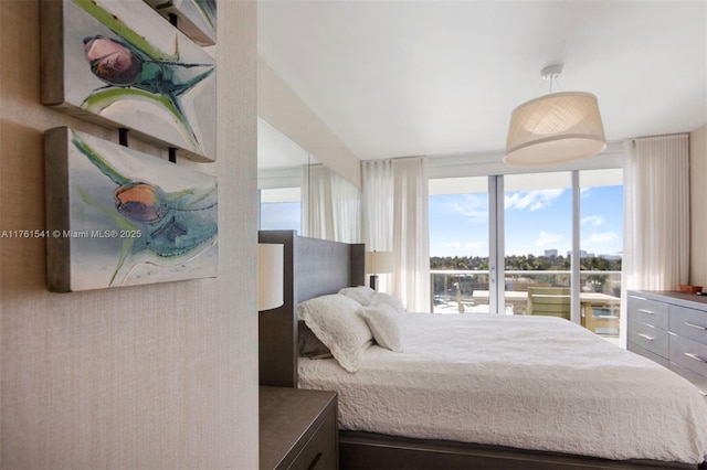 bedroom featuring expansive windows