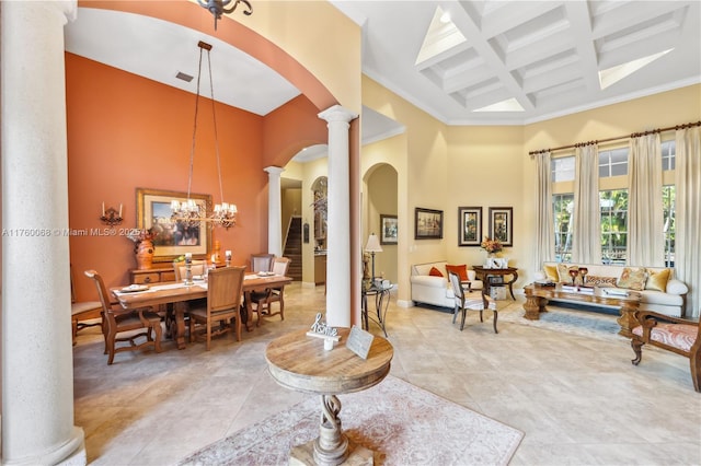 living area with beam ceiling, coffered ceiling, an inviting chandelier, a towering ceiling, and ornate columns