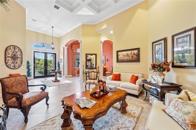 living area with coffered ceiling, arched walkways, crown molding, light tile patterned floors, and a towering ceiling