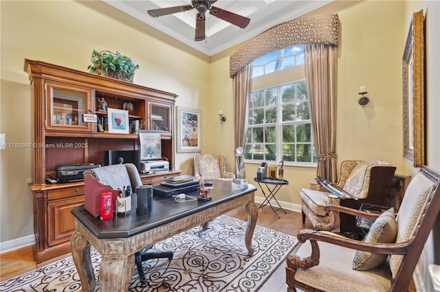 office area with ornamental molding, baseboards, light wood finished floors, and ceiling fan