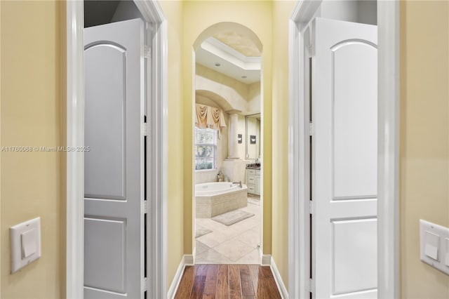 corridor featuring dark wood-style flooring