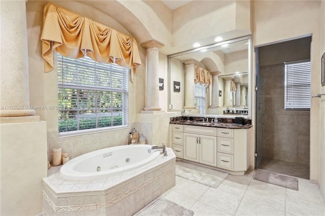 full bath with vanity, a jetted tub, a shower stall, and tile patterned flooring