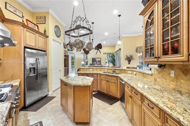 kitchen with ornamental molding, appliances with stainless steel finishes, light stone countertops, and a sink